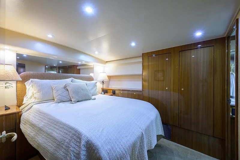 Slide: The Image of Luxurious bedroom interior of 2005 Viking 61 yacht with elegant wood paneling. - 21