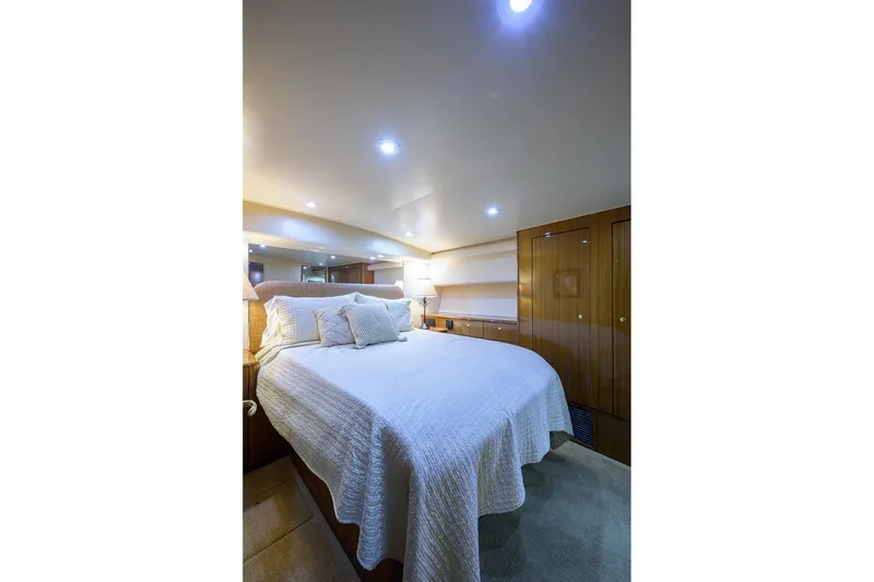 Slide: The Image of Luxurious bedroom interior of 2005 Viking 61 yacht with elegant bedding and ambient lighting. - 22