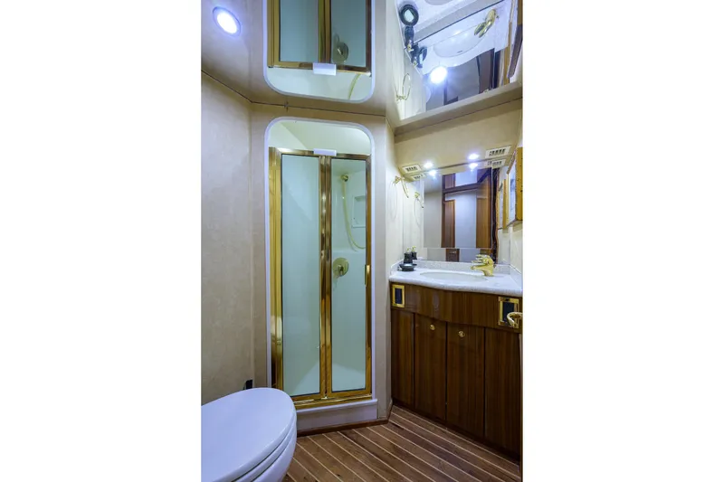 Slide: The Image of Luxurious bathroom in 2005 Viking 61 yacht with wood accents and modern fixtures. - 25