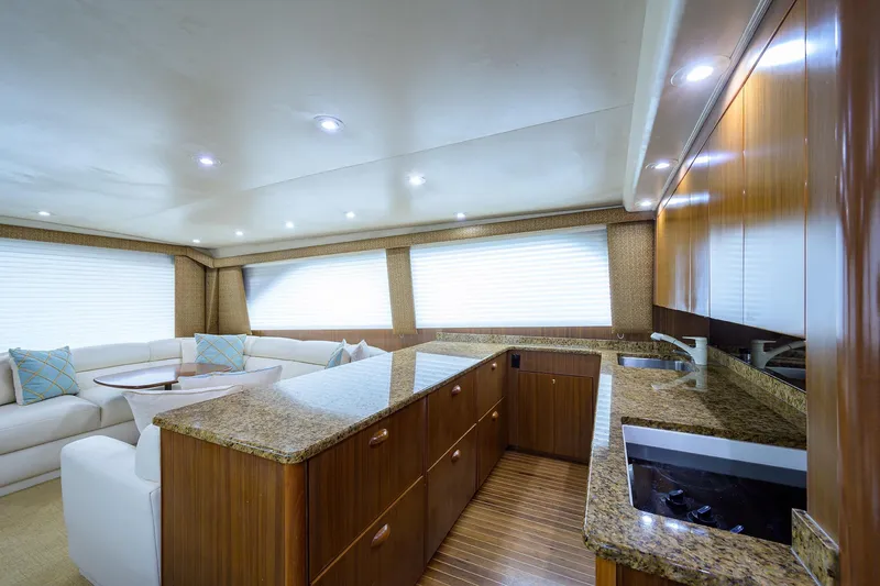 Slide: The Image of Luxurious interior of 2005 Viking 61 yacht with modern kitchen and seating area. - 26