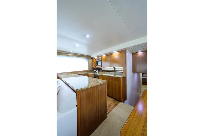 Slide: The Image of Luxurious interior of 2005 Viking 61 yacht with wooden cabinetry and granite countertops. - 28