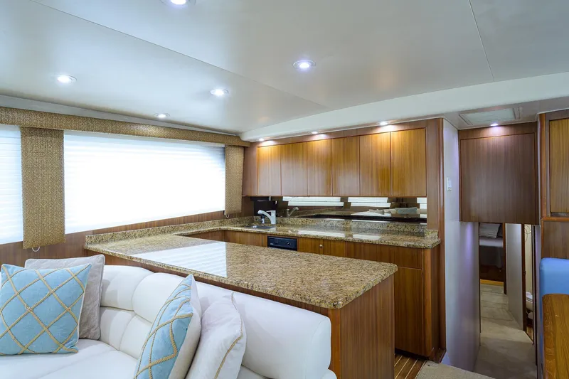 Slide: The Image of Luxurious interior of a 2005 Viking 61 yacht with modern kitchen and seating area. - 30