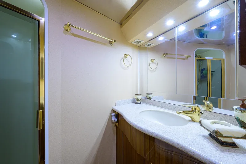 Slide: The Image of Luxurious bathroom in 2005 Viking 61 yacht with elegant fixtures and mirrored cabinetry. - 31