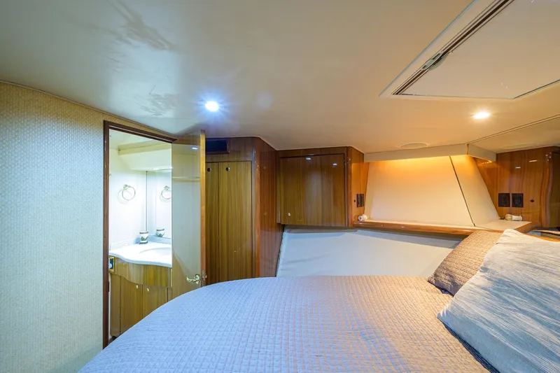 Slide: The Image of Luxurious cabin interior of 2005 Viking 61 yacht with cozy bed and ensuite bathroom. - 34