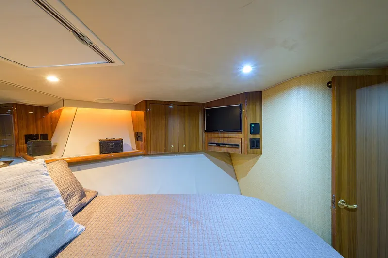 Slide: The Image of Luxurious cabin interior of a 2005 Viking 61 yacht with wood paneling and modern amenities. - 35