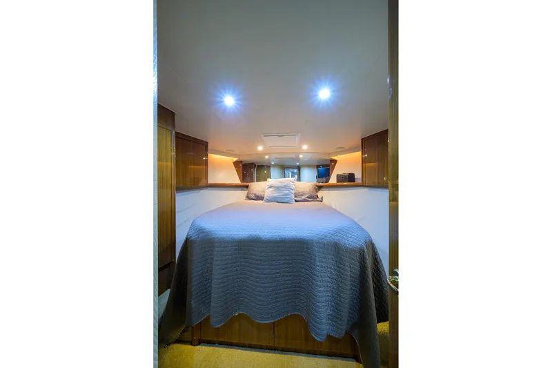 Slide: The Image of Luxurious bedroom interior of 2005 Viking 61 yacht with cozy lighting and elegant decor. - 37
