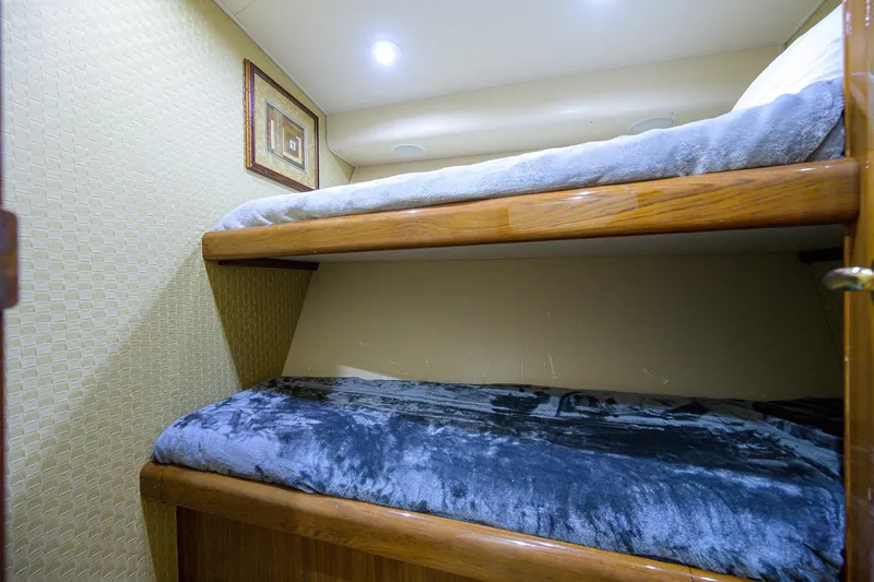 Slide: The Image of Bunk beds in 2005 Viking 61 yacht cabin with cozy bedding and wall art. - 38