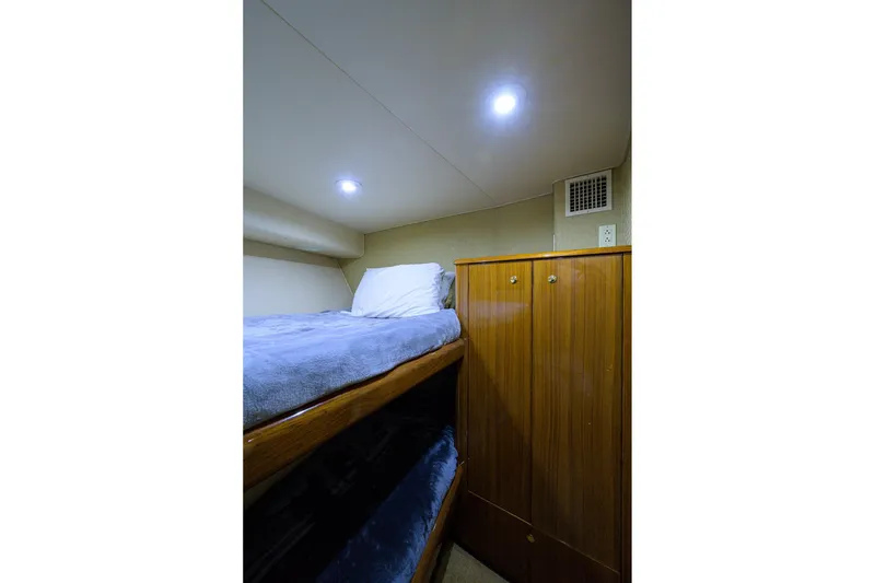 Slide: The Image of Cozy cabin interior of 2005 Viking 61 yacht with bunk beds and wooden cabinetry. - 39