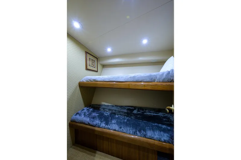 Slide: The Image of Bunk beds in 2005 Viking 61 yacht cabin with cozy lighting and framed artwork. - 40