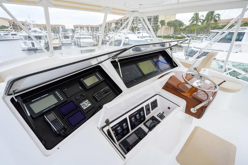 Slide: The Image of Control panel of a 2005 Viking 61 yacht, featuring advanced navigation equipment. - 41