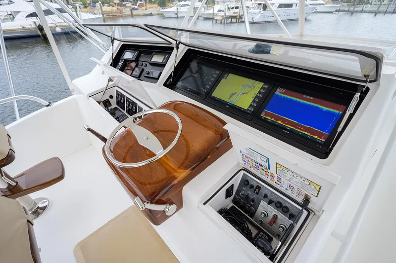 Slide: The Image of Control panel of a 2005 Viking 61 yacht with navigation screens and controls. - 44