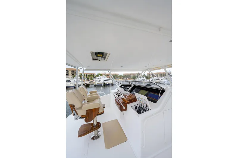 Slide: The Image of Helm of 2005 Viking 61 yacht with beige seats and navigation equipment. - 45