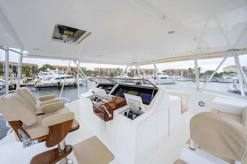 Slide: The Image of Luxurious 2005 Viking 61 yacht helm with leather seats and marina view. - 46