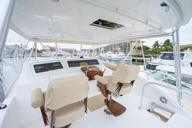 Slide: The Image of Luxurious helm of 2005 Viking 61 yacht with beige seating and modern controls. - 47