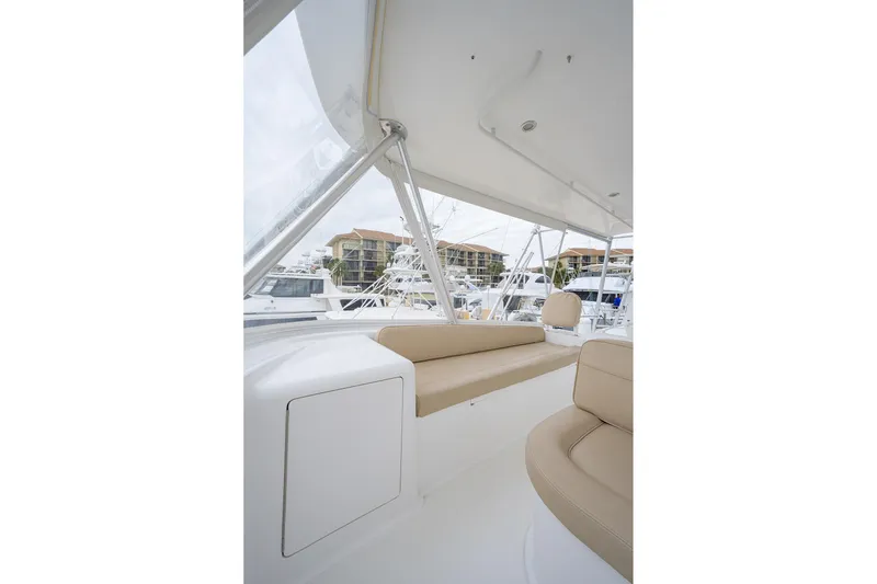 Slide: The Image of 2005 Viking 61 yacht interior with beige seating and marina view. - 49