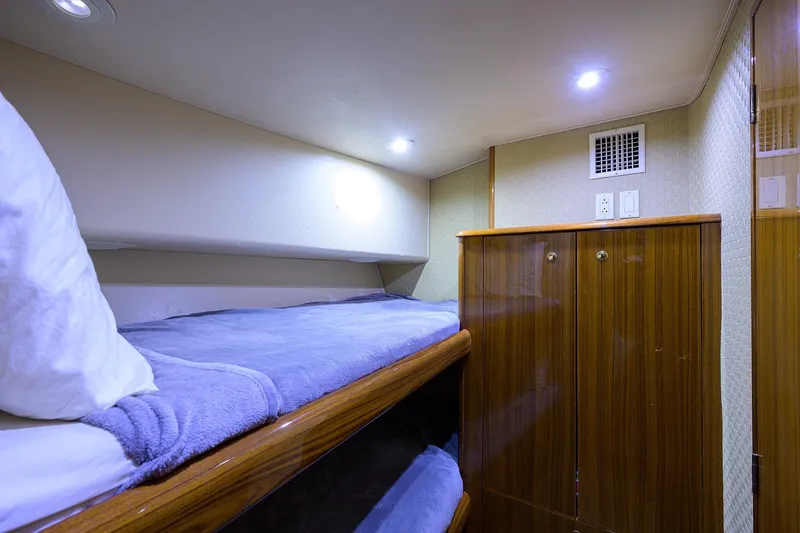 Slide: The Image of Cozy cabin interior of 2005 Viking 61 yacht with bunk beds and wooden cabinetry. - 51