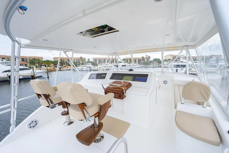 Slide: The Image of 2005 Viking 61 yacht helm with dual captain chairs and navigation equipment. - 60