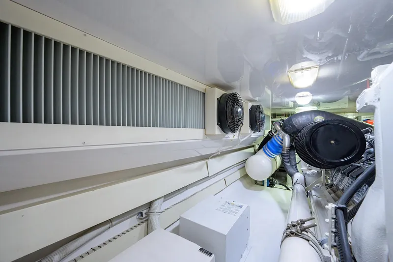 Slide: The Image of Engine room of a 2005 Viking 61 yacht, featuring ventilation and machinery components. - 61