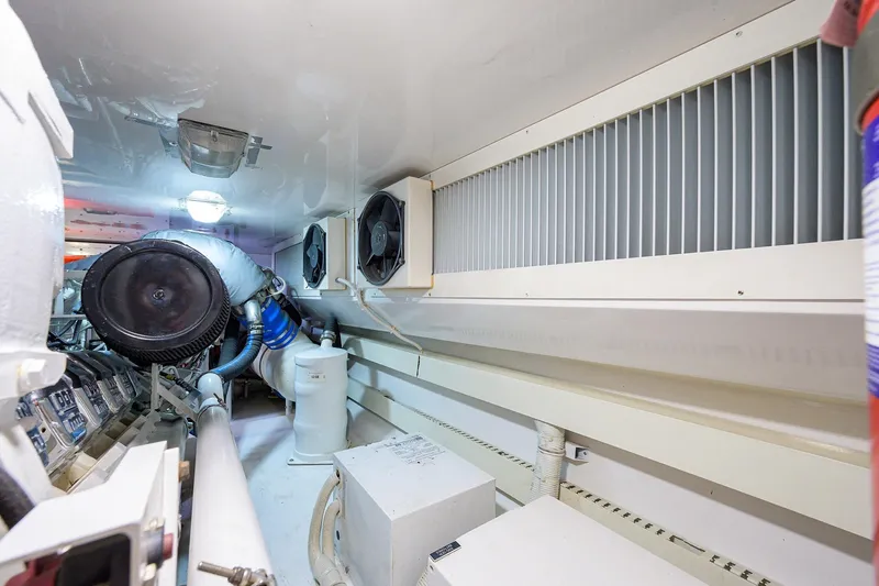 Slide: The Image of Engine room of a 2005 Viking 61 yacht, featuring ventilation and machinery components. - 62