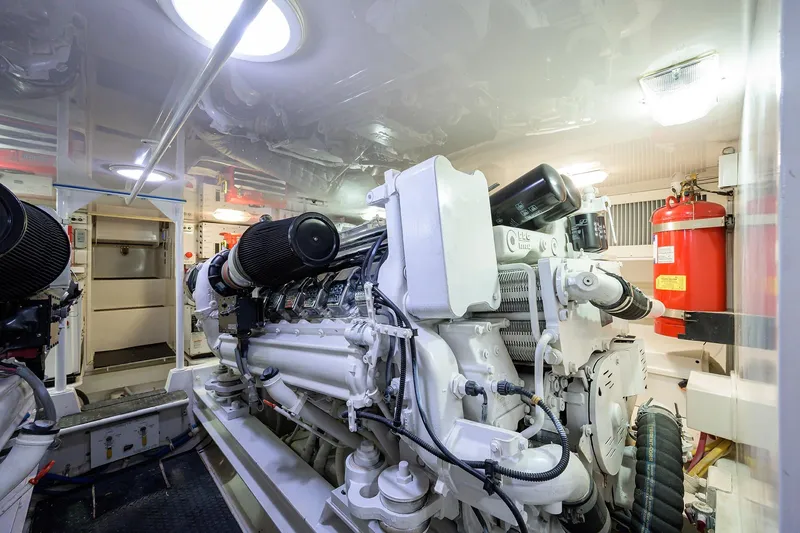 Slide: The Image of Engine room of a 2005 Viking 61 yacht, featuring a powerful marine engine. - 63