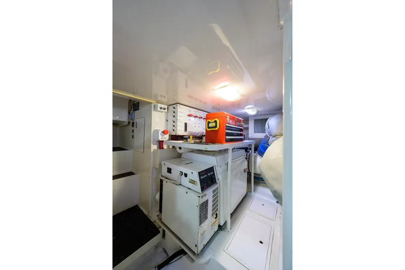 Slide: The Image of Engine room of 2005 Viking 61 yacht with equipment and tools. - 65