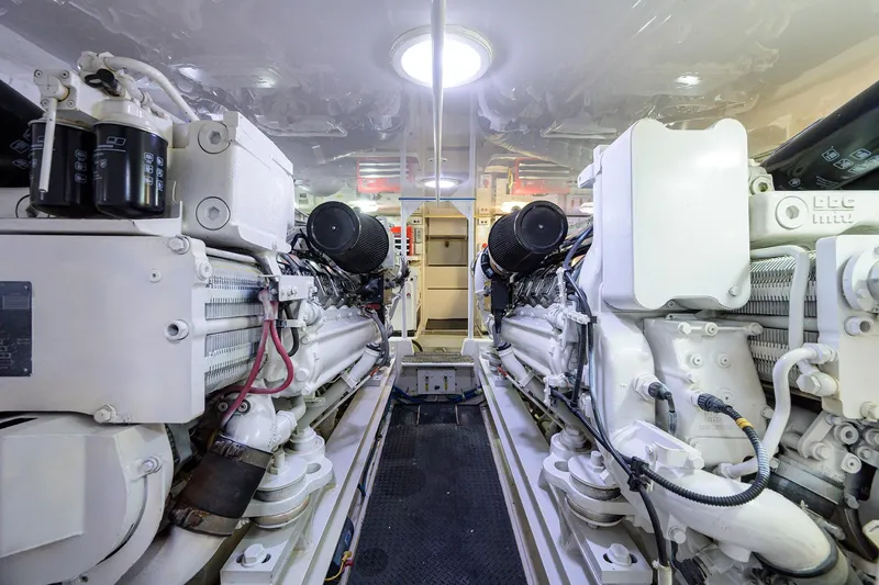 Slide: The Image of Engine room of a 2005 Viking 61 yacht, showcasing dual engines and mechanical components. - 68