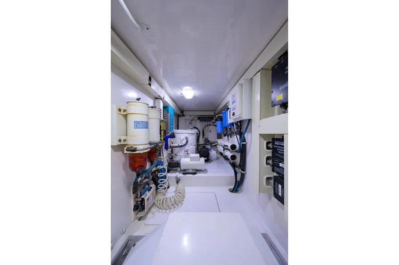 Slide: The Image of Engine room of 2005 Viking 61 yacht, showcasing mechanical systems and equipment. - 69