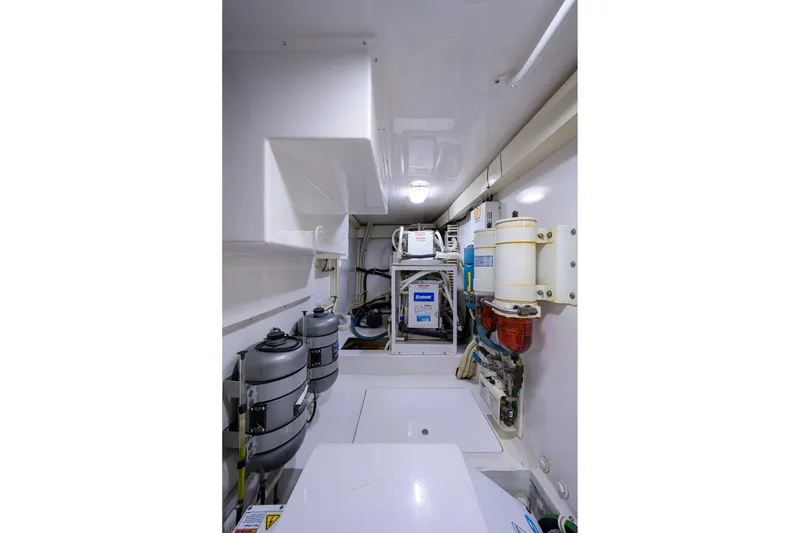 Slide: The Image of Engine room of 2005 Viking 61 yacht, featuring advanced mechanical systems and equipment. - 72