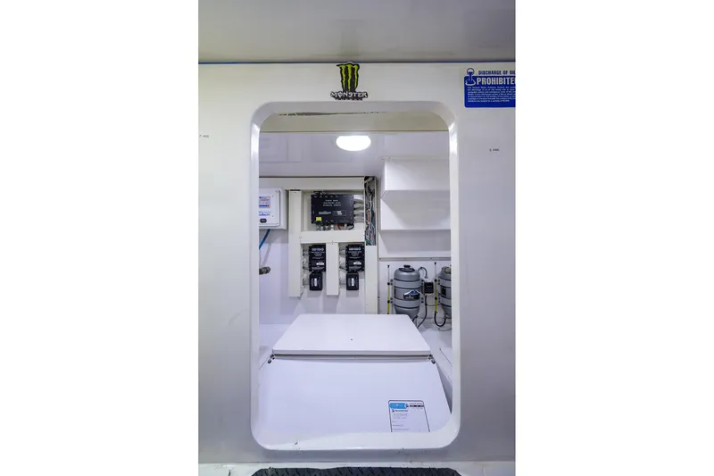 Slide: The Image of Engine room of a 2005 Viking 61 yacht, featuring control panels and equipment. - 74