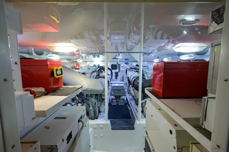 Slide: The Image of Engine room of a 2005 Viking 61 yacht, featuring organized equipment and red toolboxes. - 75