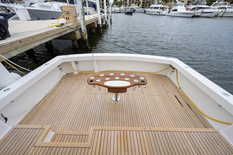 Slide: The Image of 2005 Viking 61 yacht deck with wooden flooring and fishing station at marina. - 78