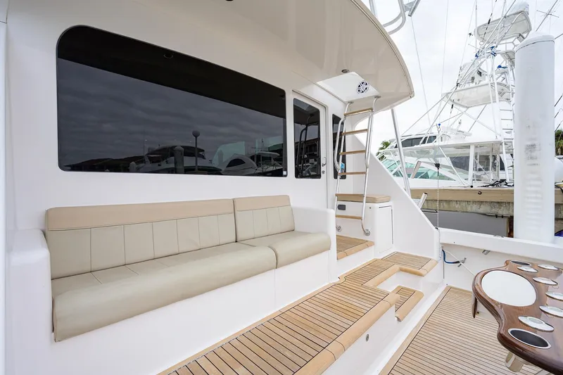 Slide: The Image of 2005 Viking 61 yacht deck with beige seating and wooden flooring. - 80