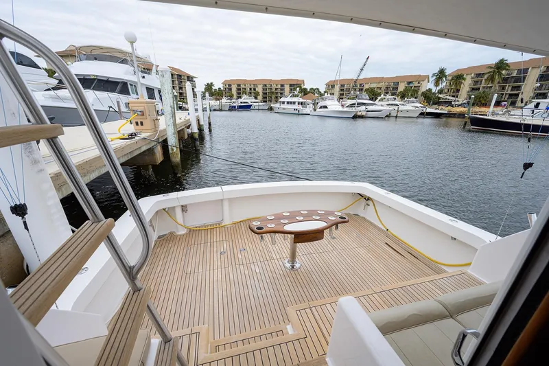 Slide: The Image of 2005 Viking 61 yacht deck overlooking marina with boats and waterfront buildings. - 85