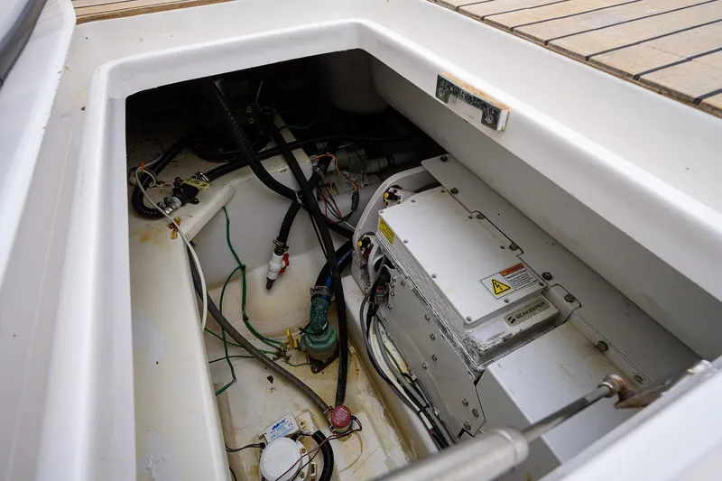 Slide: The Image of Engine compartment of a 2005 Viking 61 yacht, showing mechanical components and wiring. - 86
