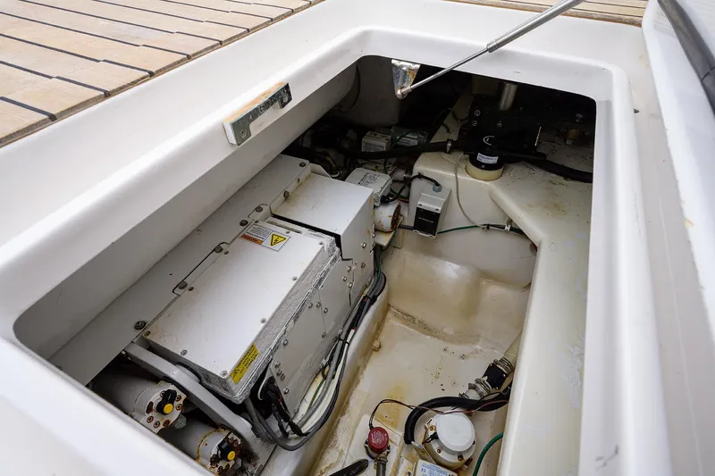Slide: The Image of Engine compartment of a 2005 Viking 61 yacht, showcasing mechanical components and wiring. - 87