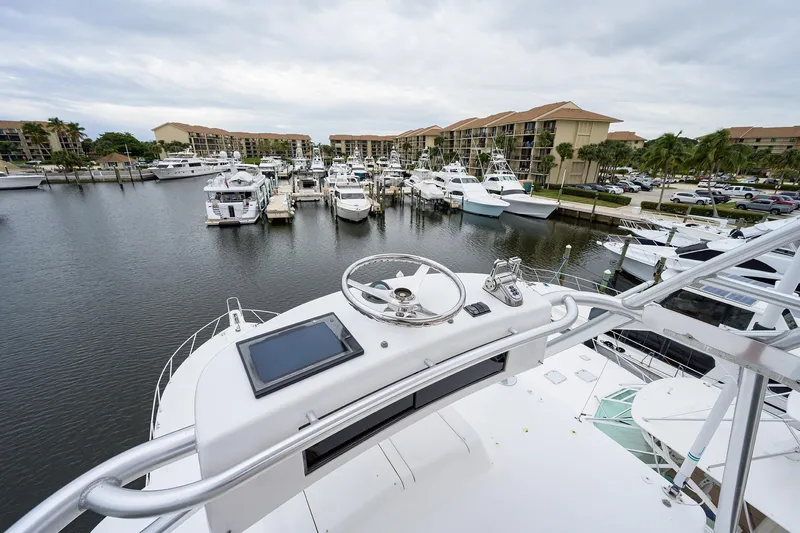 Slide: The Image of Aerial view from 2005 Viking 61 yacht helm overlooking marina with multiple boats docked. - 89