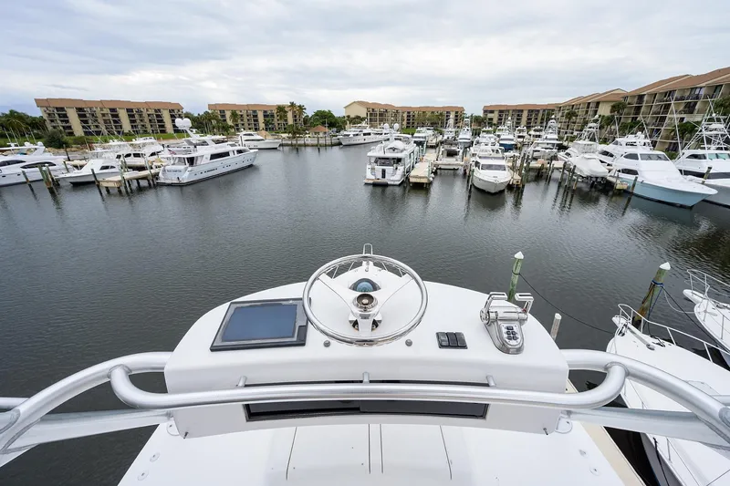 Slide: The Image of View from 2005 Viking 61 yacht helm overlooking marina with multiple boats docked. - 90