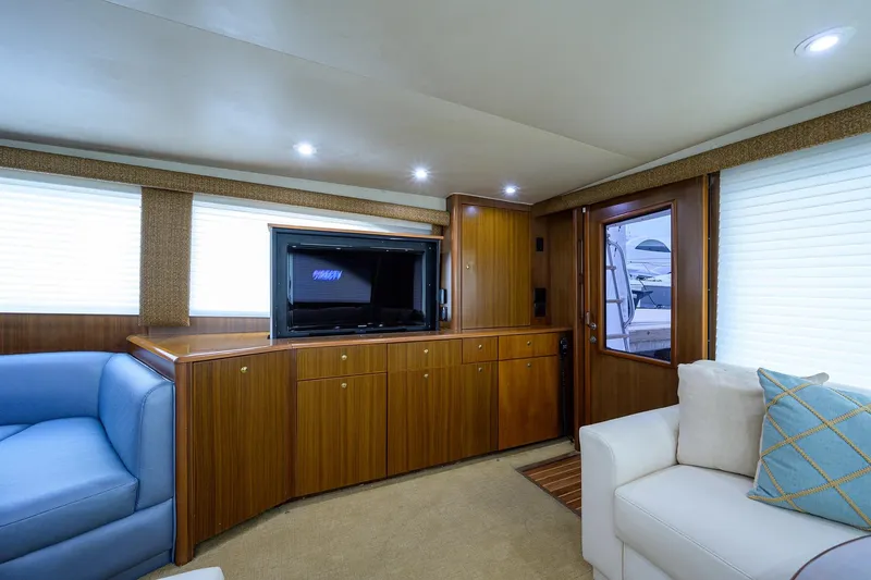 Slide: The Image of Luxurious interior of 2005 Viking 61 yacht with wood cabinetry and comfortable seating. - 92