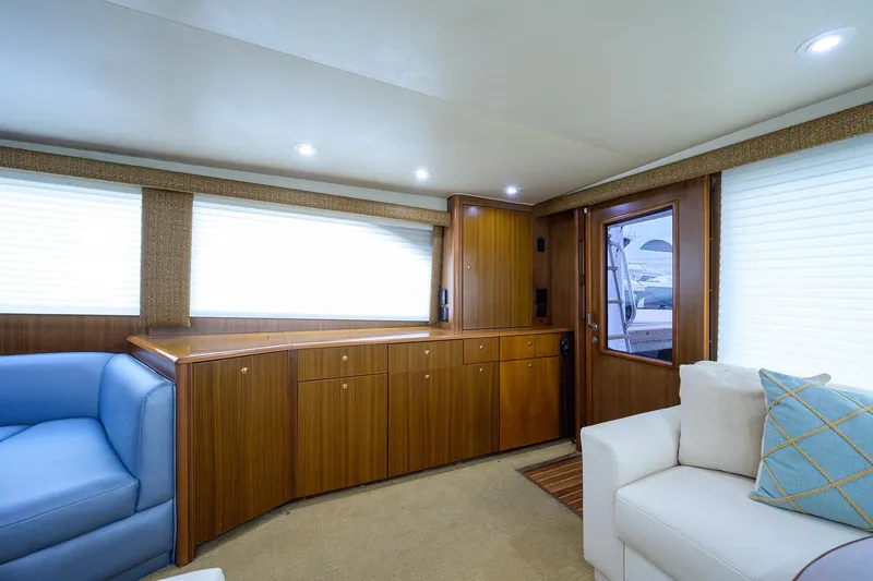 Slide: The Image of Luxurious interior of a 2005 Viking 61 yacht with wood cabinetry and plush seating. - 93