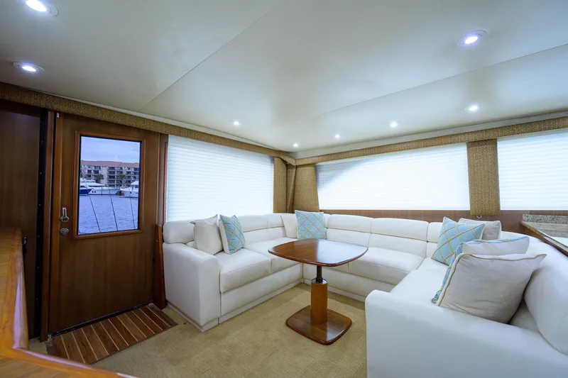 Slide: The Image of Luxurious interior of 2005 Viking 61 yacht with white seating and wooden accents. - 94