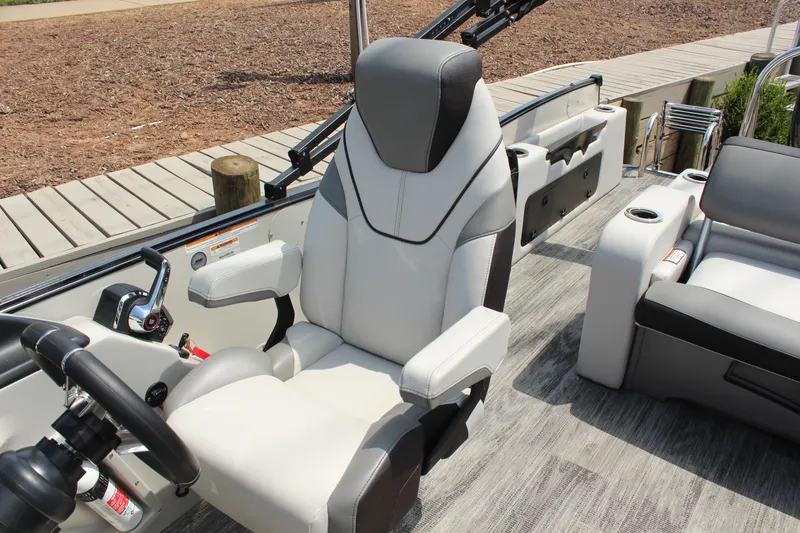 Slide: The Image of 2023 Tahoe Pontoon Cascade Platinum Versatile Rear Bench 23' interior with captain's chair. - 12