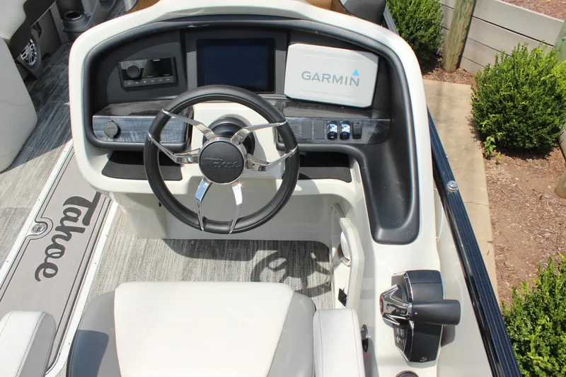 Slide: The Image of 2023 Tahoe Pontoon Cascade Platinum helm with Garmin navigation system and sleek steering wheel. - 14