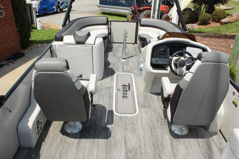 Slide: The Image of 2023 Tahoe Pontoon Cascade Platinum Versatile Rear Bench interior with modern seating and steering console. - 18