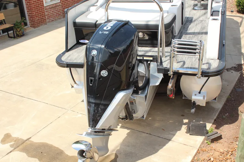 Slide: The Image of 2023 Tahoe Pontoon Cascade Platinum Versatile Rear Bench with powerful outboard motor. - 7