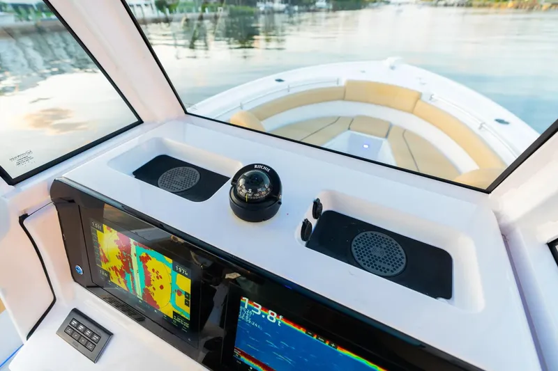 Slide: The Image of 2026 Sportsman Open 232 Center Console boat interior with modern helm and seating. - 10
