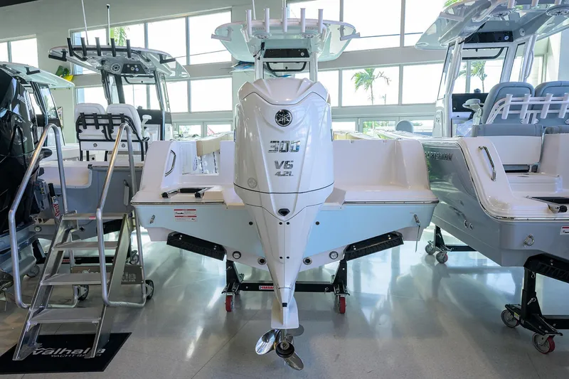 Slide: The Image of 2026 Sportsman Open 232 Center Console boat displayed indoors with powerful engine. - 18
