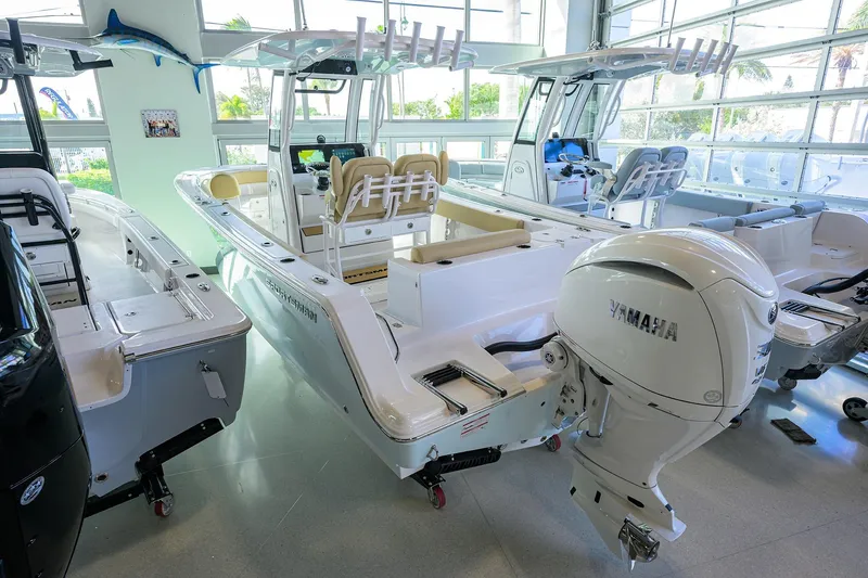 Slide: The Image of 2026 Sportsman Open 232 Center Console boat in showroom with Yamaha engine. - 19