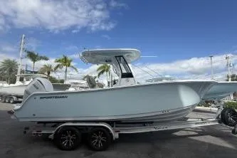 Slide: The Image of 2026 Sportsman Open 232 Center Console boat on trailer, under clear blue sky. - 21