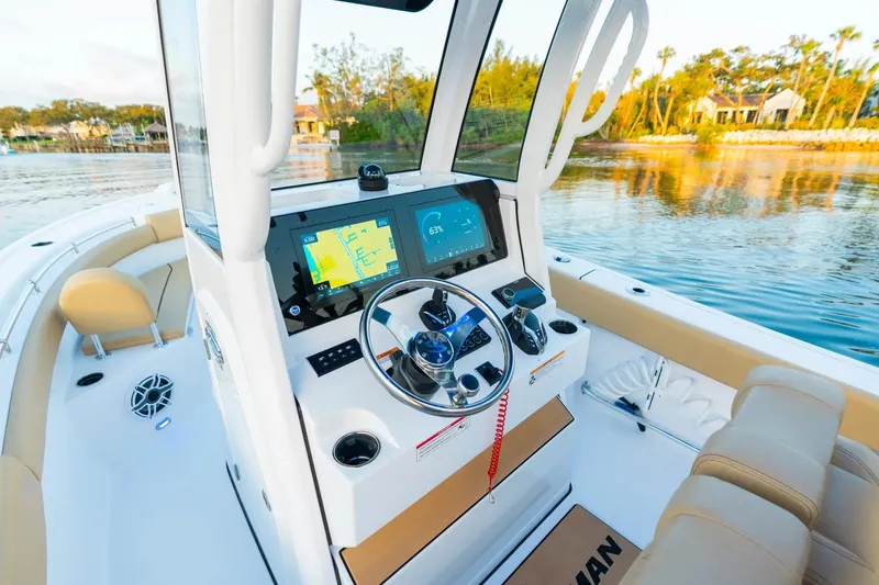 Slide: The Image of 2026 Sportsman Open 232 Center Console boat interior in showroom with modern features. - 6