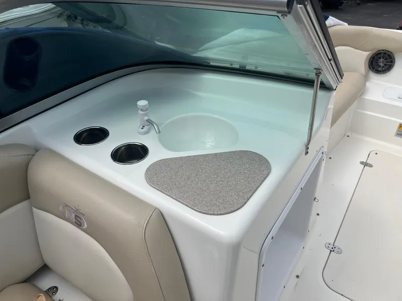 Slide: The Image of 2016 NauticStar 203DC Sport Deck boat interior with sink and cup holders. - 11
